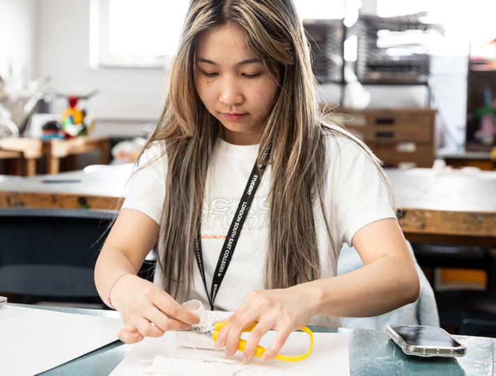 student working at desk in art studio