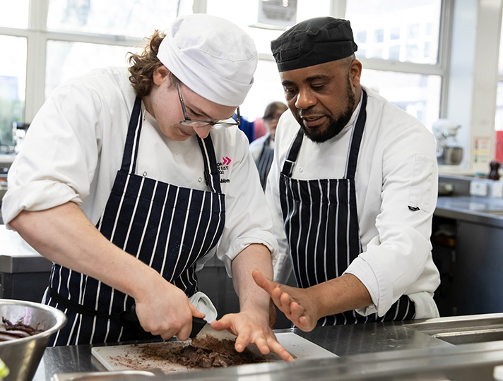 Student learning how to prepare dish