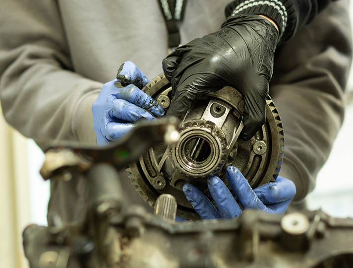 Student learning the mechanisms of a car 